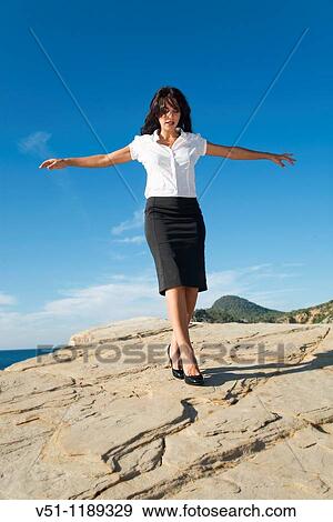 Portrait of a business woman relaxing in a cliff View Large Photo Image Stock Photo - Portrait of a business woman relaxing in a cliff. Fotosearch