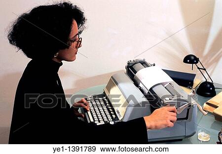 Portrait of a business woman typing on an old fashioned typewriter View Large Photo Image Stock Photo - Portrait of a business woman typing on an old fashioned typewriter. Fotosearch