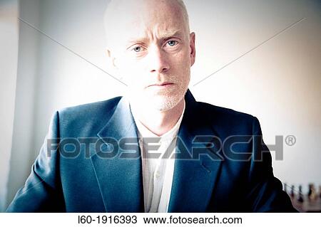 Stock Image - Portrait of a businessman thinking. Fotosearch