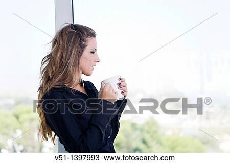 Portrait of a businesswoman looking through the window View Large Photo Image Stock Image - Portrait of a businesswoman looking through the window. Fotosearch