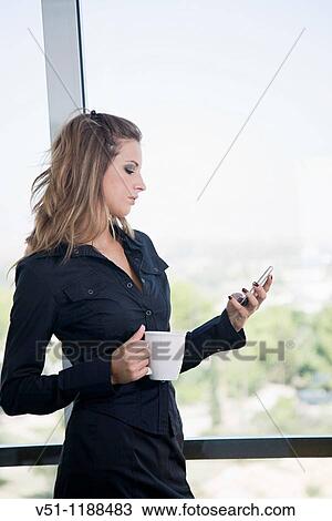 Portrait of a businesswoman with mobile and a cup of coffee View Large Photo Image Stock Image - Portrait of a businesswoman with mobile and a cup of coffee. Fotosearch