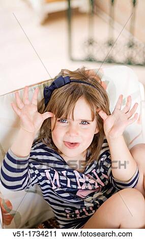 Stock Image - Portrait of a caucasian girl making a face. Fotosearch