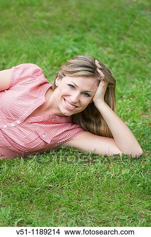 Portrait of a content blonde woman in the park View Large Photo Image Picture - Portrait of a content blonde woman in the park. Fotosearch