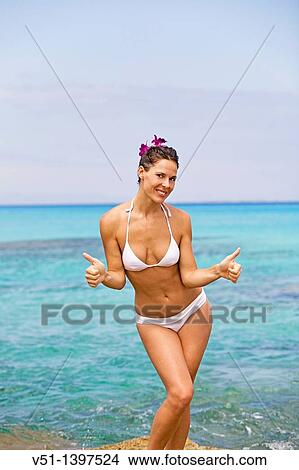 Portrait of a content brunette woman at the beach View Large Photo Image Picture - Portrait of a content brunette woman at the beach. Fotosearch