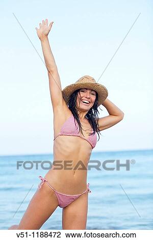 Portrait of a content brunette woman at the beach in Ibiza, Balearic Island View Large Photo Image Stock Image - Portrait of a content brunette woman at the beach in Ibiza, Balearic Island. Fotosearch