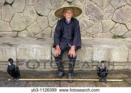 Stock Photo - Portrait Of A Cormorant Fisherman, Yangshuo, China. Fotosearch