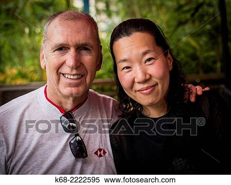 Stock Photography - portrait of a couple, a caucasian man and Japanese woman in Vancouver, BC, Canada.. Fotosearch