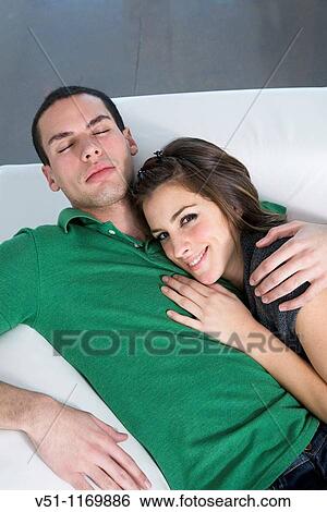 Portrait of a couple at home in the sofa View Large Photo Image Stock Photograph - Portrait of a couple at home in the sofa. Fotosearch