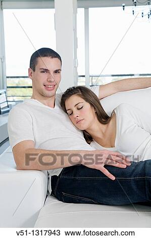 Portrait of a couple at home relaxing in the sofa View Large Photo Image Stock Image - Portrait of a couple at home relaxing in the sofa. Fotosearch