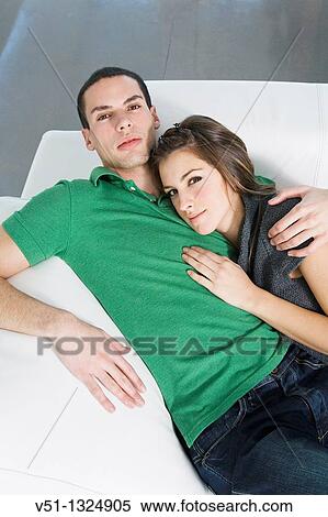Portrait of a couple chilling in sofa View Large Photo Image Stock Photography - Portrait of a couple chilling in sofa. Fotosearch