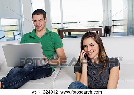 Portrait of a couple enjoying leisure time at home View Large Photo Image Stock Image - Portrait of a couple enjoying leisure time at home. Fotosearch