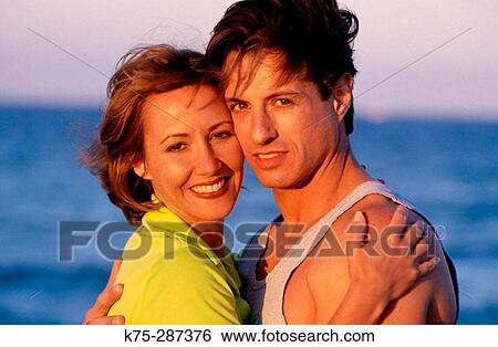Stock Photograph - Portrait of a couple hugging. Fotosearch