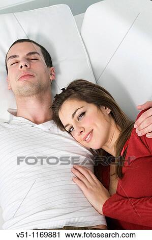 Stock Image - Portrait of a couple in sofa at home. Fotosearch