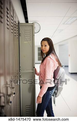 Portrait of a female Asian student and her locker in the school hallway. View Large Photo Image Stock Image - Portrait of a female Asian student and her locker in the school hallway.. Fotosearch