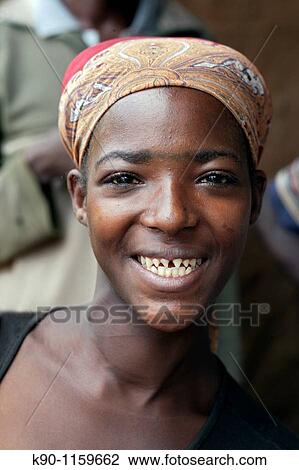 Portrait of a friendly smiling young lady from the Bench tribe showing her sharpened front teeth, Ethiopia, East Africa. View Large Photo Image Stock Image - Portrait of a friendly smiling young lady from the Bench tribe showing her sharpened front teeth, Ethiopia, East Africa.. Fotosearch