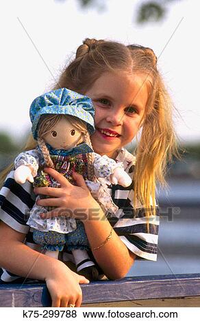 Stock Photo - portrait of a girl and her doll. Fotosearch