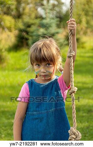 Stock Image - Portrait of a girl holding rope.. Fotosearch