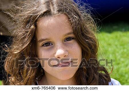 Portrait of a girl looking at camera with a tender look. Foreign exposure View Large Photo Image Stock Photograph - Portrait of a girl looking at camera with a tender look. Foreign exposure. Fotosearch