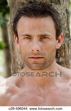 Portrait of a good-looking man by a tree in India. View Large Photo Image Picture - Portrait of a good-looking man by a tree in India.. Fotosearch