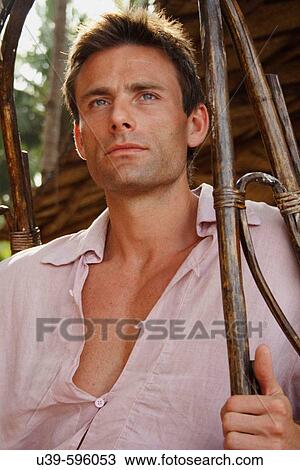 Portrait of a good-looking man sat in a hanging chair in India. View Large Photo Image Stock Image - Portrait of a good-looking man sat in a hanging chair in India.. Fotosearch