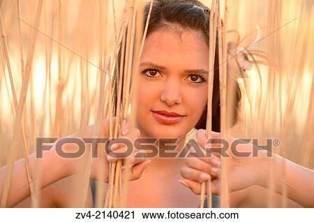 Portrait of a good looking young woman in the reeds at sunset in early spring. View Large Photo Image Stock Image - Portrait of a good looking young woman in the reeds at sunset in early spring.. Fotosearch