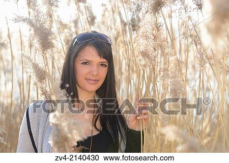 Portrait of a good looking young woman in the reeds on a sunny day in early spring. View Large Photo Image Stock Image - Portrait of a good looking young woman in the reeds on a sunny day in early spring.. Fotosearch