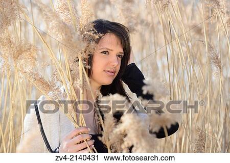 Portrait of a good looking young woman in the reeds on a sunny day in early spring. View Large Photo Image Stock Image - Portrait of a good looking young woman in the reeds on a sunny day in early spring.. Fotosearch