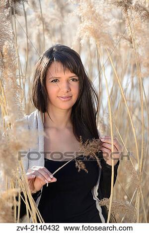 Portrait of a good looking young woman in the reeds on a sunny day in early spring. View Large Photo Image Stock Image - Portrait of a good looking young woman in the reeds on a sunny day in early spring.. Fotosearch