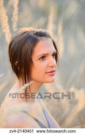 Portrait of a good looking young woman in the reeds at sunset in early spring. View Large Photo Image Stock Image - Portrait of a good looking young woman in the reeds at sunset in early spring.. Fotosearch