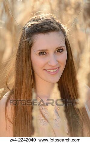 Portrait of a good looking young woman in the reeds on a sunny day in early spring. View Large Photo Image Stock Image - Portrait of a good looking young woman in the reeds on a sunny day in early spring.. Fotosearch