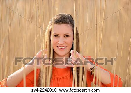 Portrait of a good looking young woman in the reeds on a sunny day in early spring. View Large Photo Image Stock Image - Portrait of a good looking young woman in the reeds on a sunny day in early spring.. Fotosearch