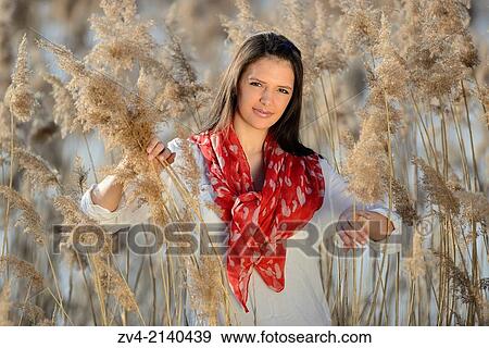 Portrait of a good looking young woman in the reeds on a sunny day in early spring. View Large Photo Image Stock Photo - Portrait of a good looking young woman in the reeds on a sunny day in early spring.. Fotosearch