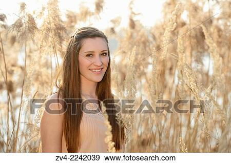 Portrait of a good looking young woman in the reeds on a sunny day in early spring. View Large Photo Image Stock Photo - Portrait of a good looking young woman in the reeds on a sunny day in early spring.. Fotosearch