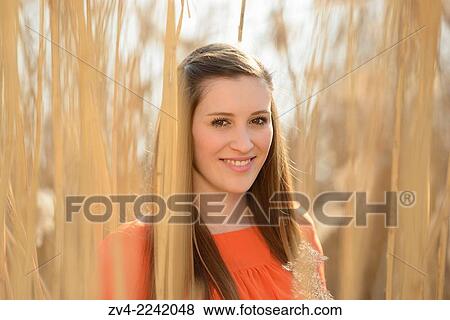 Portrait of a good looking young woman in the reeds on a sunny day in early spring. View Large Photo Image Stock Photo - Portrait of a good looking young woman in the reeds on a sunny day in early spring.. Fotosearch