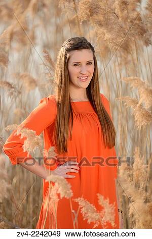 Portrait of a good looking young woman in the reeds on a sunny day in early spring. View Large Photo Image Stock Photo - Portrait of a good looking young woman in the reeds on a sunny day in early spring.. Fotosearch
