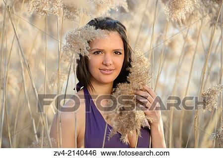 Portrait of a good looking young woman wearing a bikini in the reeds on a sunny day in early spring. View Large Photo Image Stock Photograph - Portrait of a good looking young woman wearing a bikini in the reeds on a sunny day in early spring.. Fotosearch
