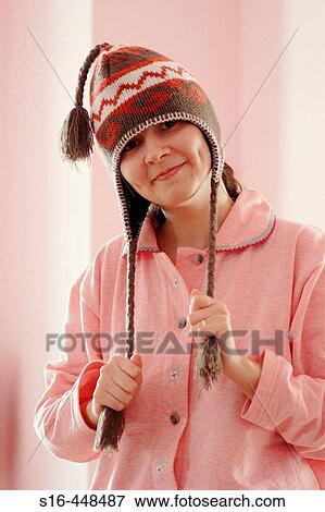 Portrait of a happy beautiful young woman dressed in pyjamas and wearing a funny hat View Large Photo Image Stock Photo - Portrait of a happy beautiful young woman dressed in pyjamas and wearing a funny hat. Fotosearch