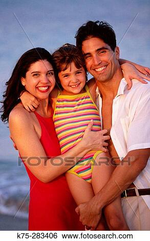 Stock Photograph - Portrait of a happy family at beach. Fotosearch