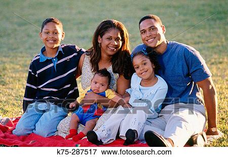 Stock Photo - Portrait of a happy family outdoors. Fotosearch