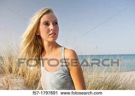 Portrait of a healthy young woman at the beach View Large Photo Image Stock Image - Portrait of a healthy young woman at the beach. Fotosearch