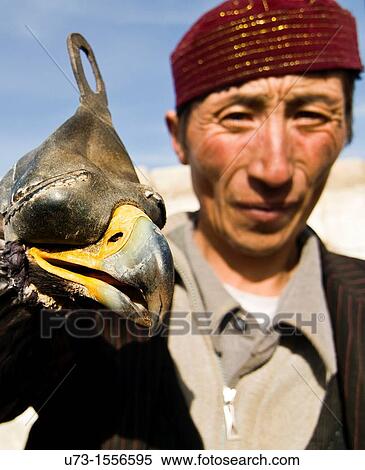 Portrait of a Kazakh eagle hunter with his eagle. View Large Photo Image Stock Photography - Portrait of a Kazakh eagle hunter with his eagle.. Fotosearch
