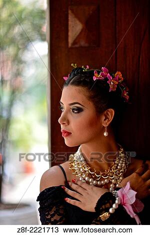Stock Image - Portrait of a Latin woman inspired by the figure of Mexican painter Frieda Kahlo.. Fotosearch
