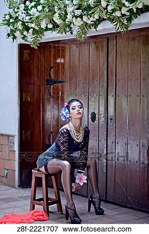 Stock Photo - Portrait of a Latin woman inspired by the figure of Mexican painter Frieda Kahlo.. Fotosearch