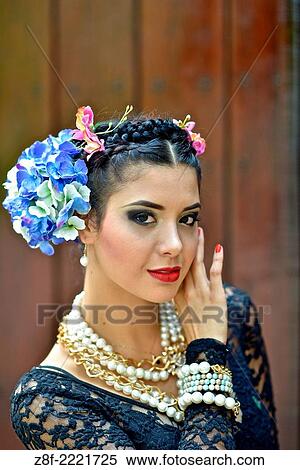Stock Photography - Portrait of a Latin woman inspired by the figure of Mexican painter Frieda Kahlo.. Fotosearch