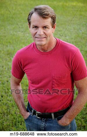 Portrait of a man in a red T-shirt View Large Photo Image Stock Photo - Portrait of a man in a red T-shirt. Fotosearch