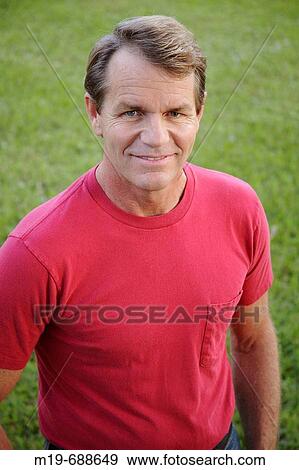 Portrait of a man in a t-shirt View Large Photo Image Stock Photo - Portrait of a man in a t-shirt. Fotosearch
