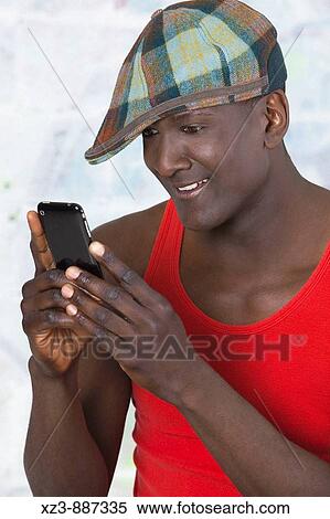 Portrait of a man looking at his phone View Large Photo Image Stock Photography - Portrait of a man looking at his phone. Fotosearch