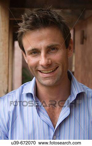 Stock Image - Portrait of a man smiling.. Fotosearch