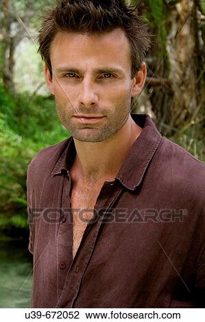Stock Image - Portrait of a man standing in a lagoon. Fraser Island, Australia. Fotosearch