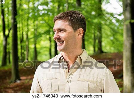 Portrait of a man trekking in the woods View Large Photo Image Stock Image - Portrait of a man trekking in the woods. Fotosearch